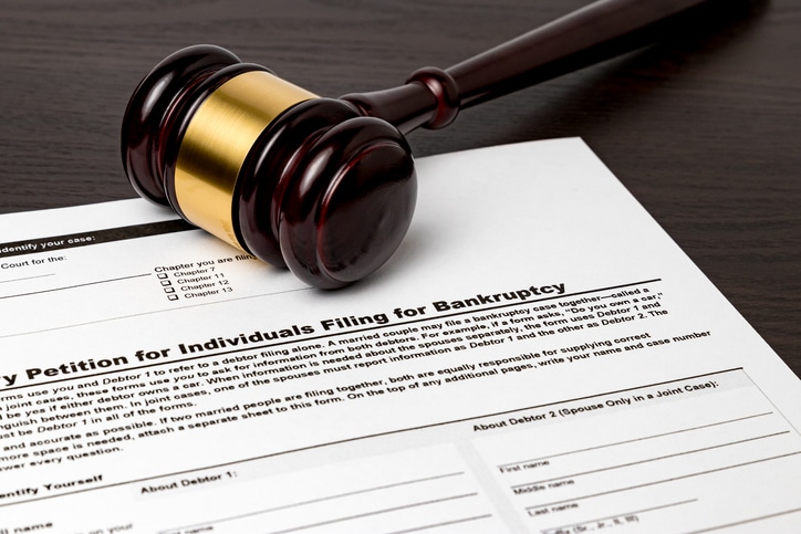 a gavel laying over bankruptcy paperwork