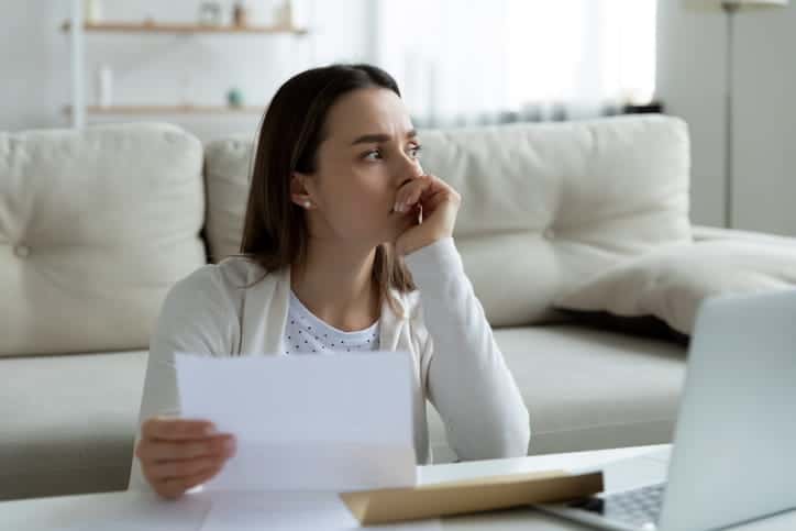 a concerned woman holding bankruptcy documents