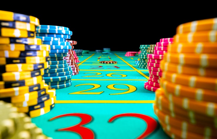 a close up view of chips on a table for the game craps