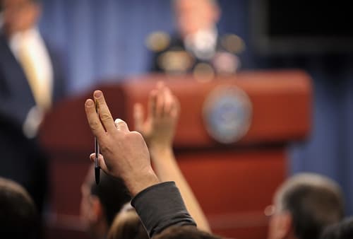 hands raised asking question