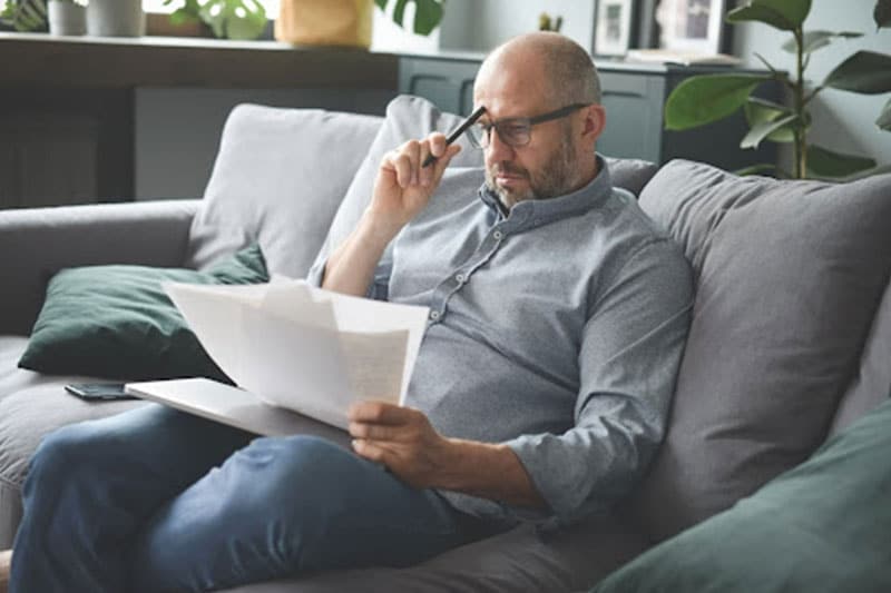 man reading bankruptcy paperwork