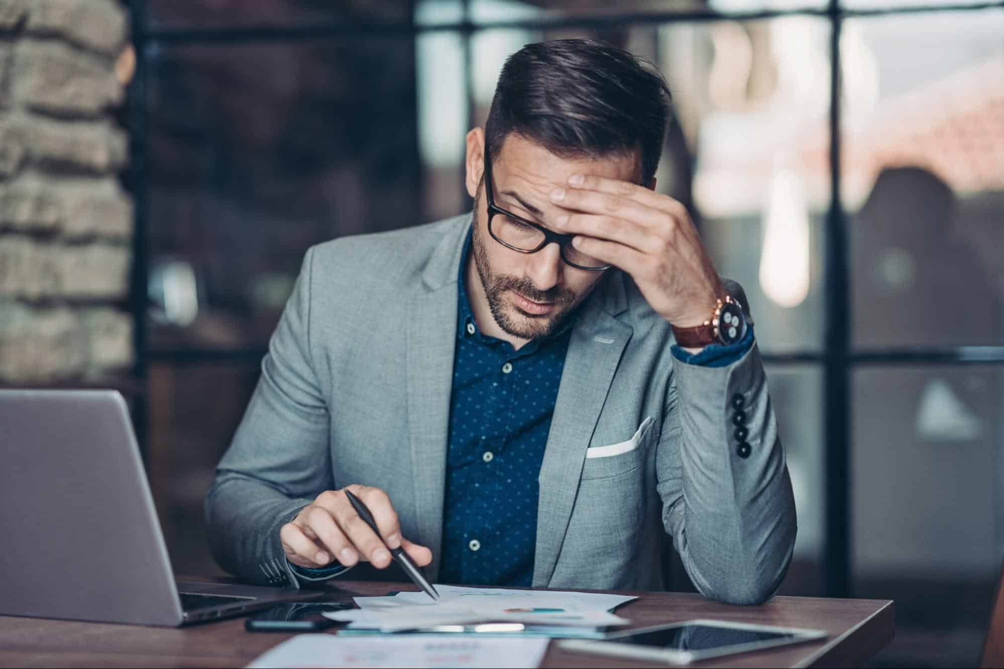 stressed man looking at bankruptcy documents