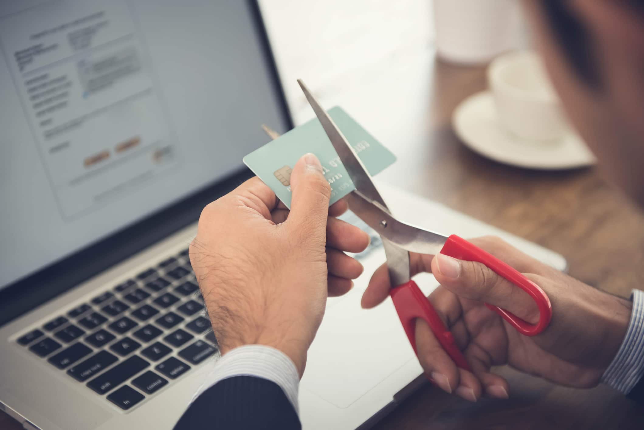 person cutting up a credit card