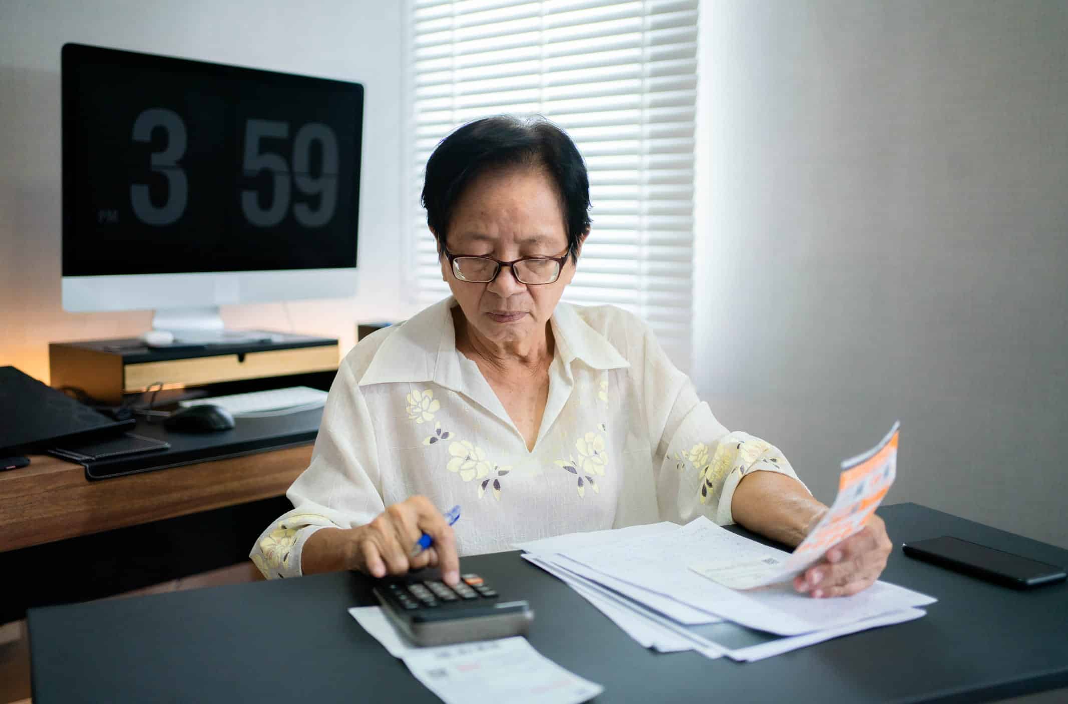 elderly person calculating expenses and filing for bankruptcy