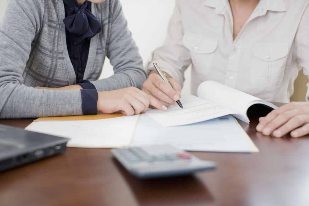 business woman filling out paper work for a loan