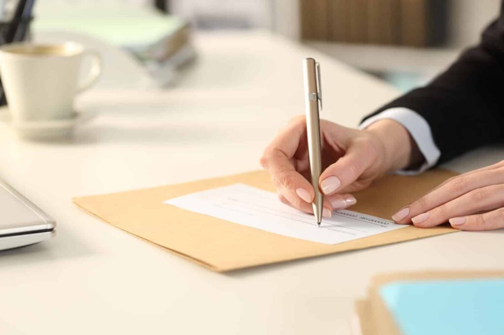 business woman filling out bank check