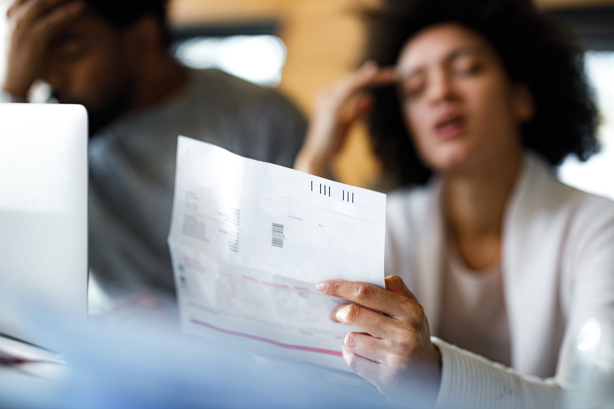 stressed out woman and man looking at bankruptcy documents