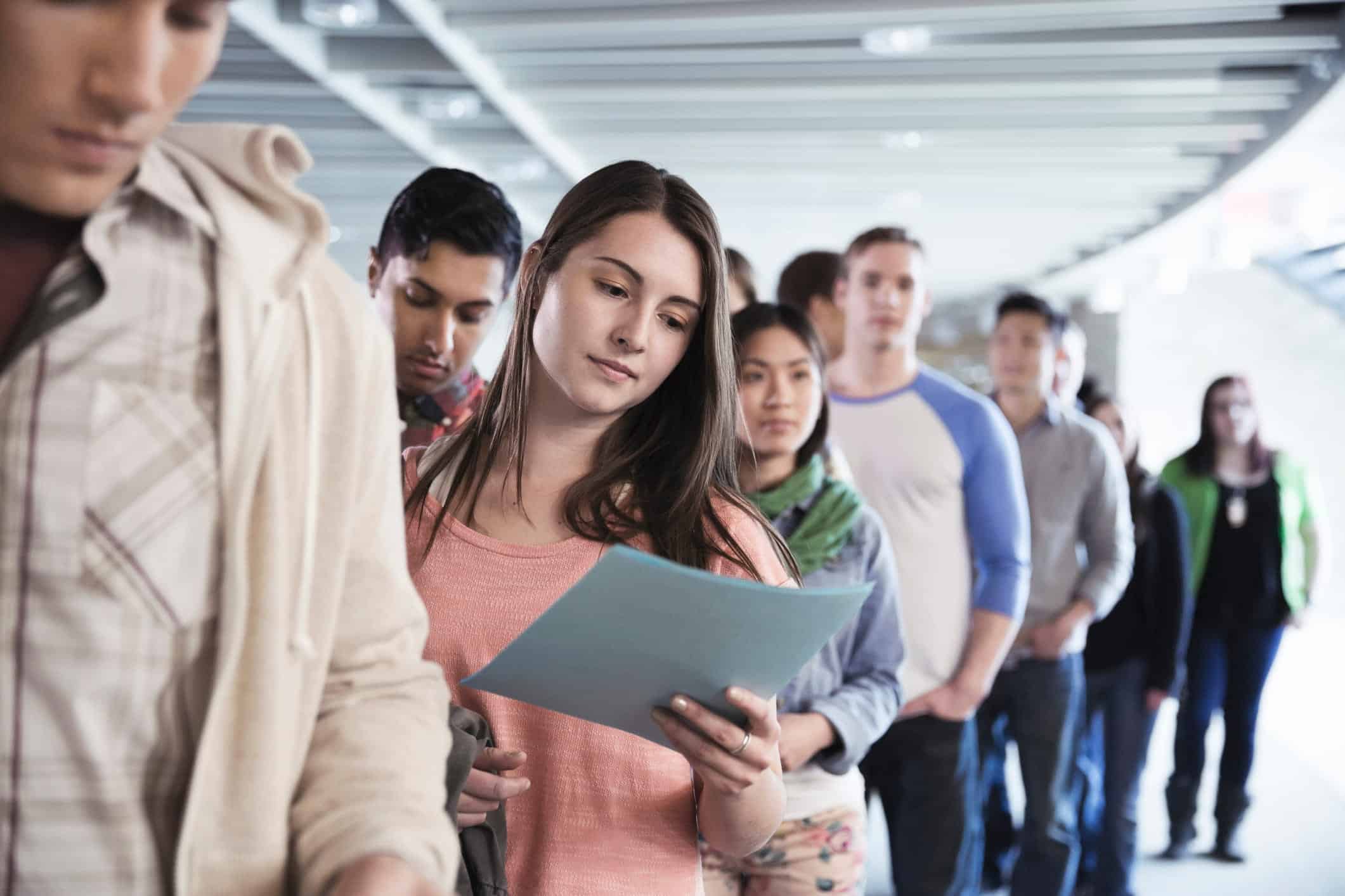 students with student loan debt lined up