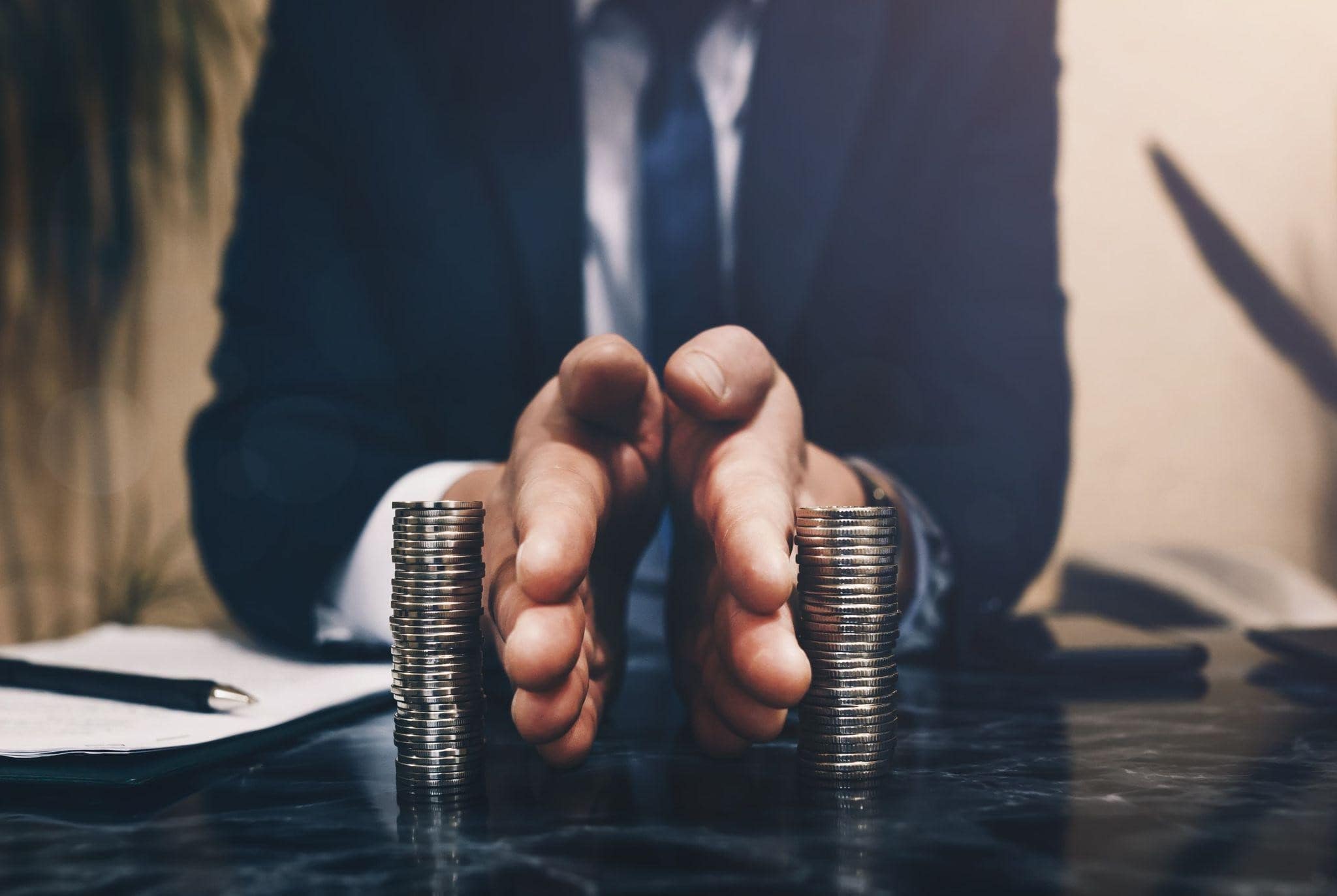 man in suit separating coins