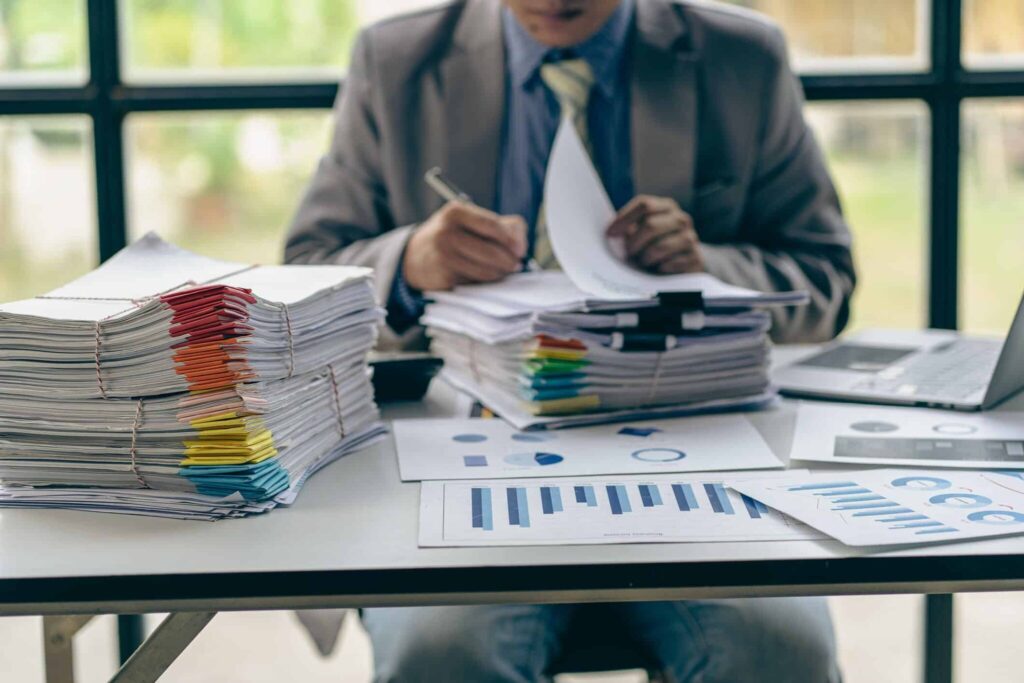 man sitting on desk filing for chapter 13 bankruptcy