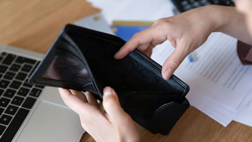 female-looking-at-empty-wallet-debating-on-bankruptcy