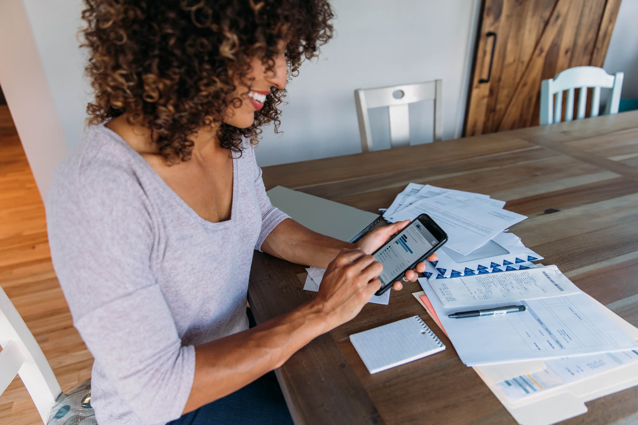 woman using bankruptcy mobile app while smiling