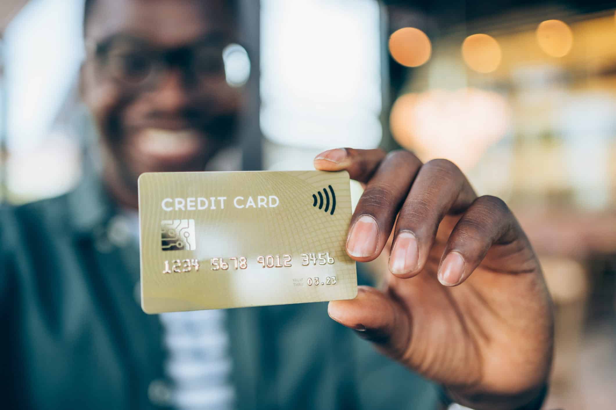 happy person holding credit card