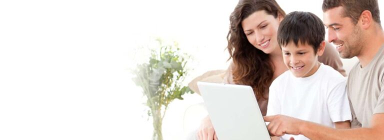 Happy Family Looking At A Laptop Screen Together