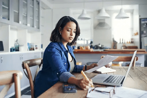 woman creating a savings plan on paper