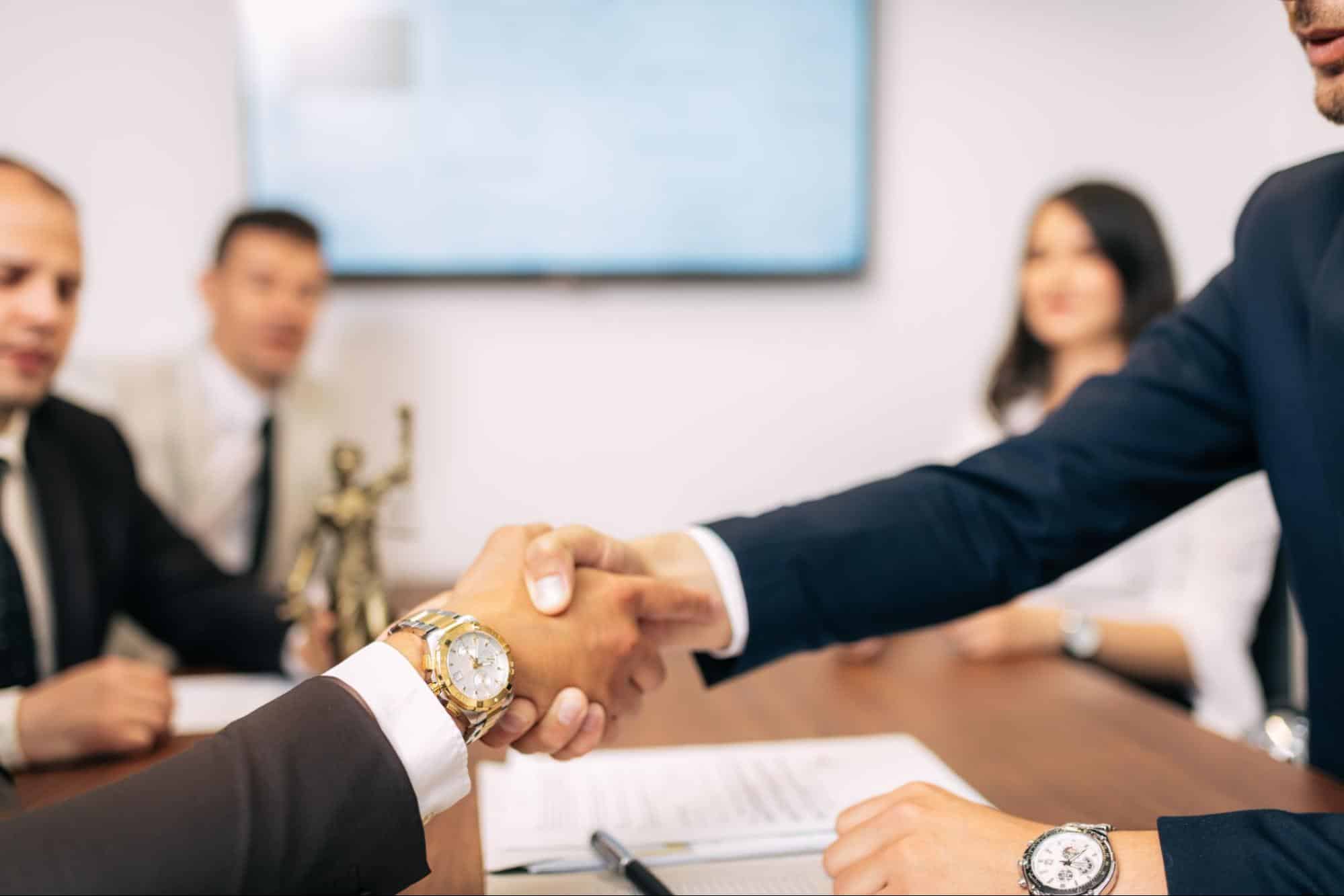 Two lawyers shaking hands