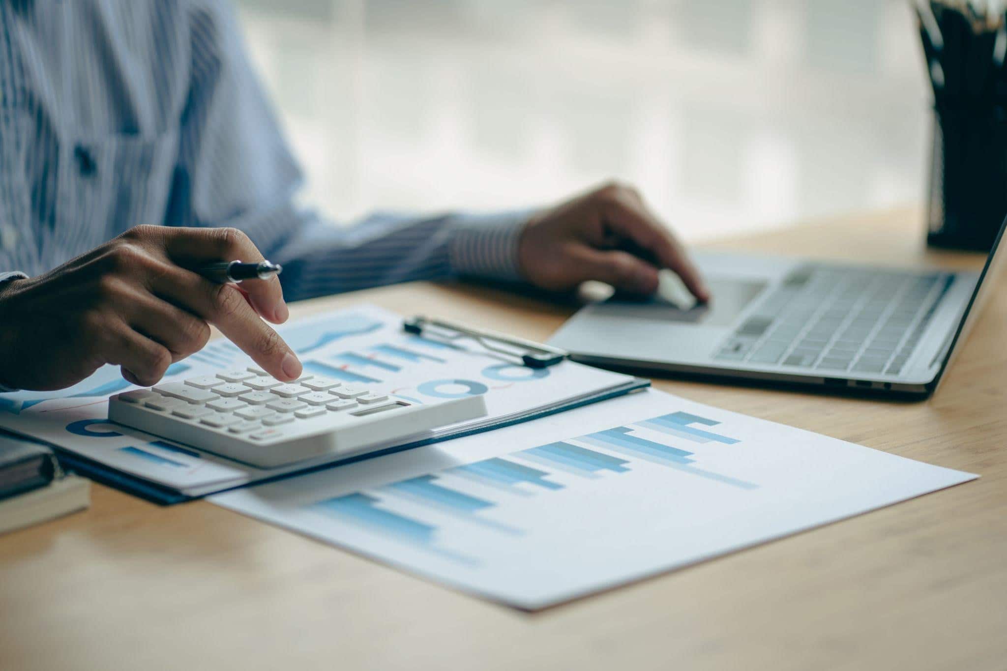 person making calculations on a desk and filing for bankruptcy